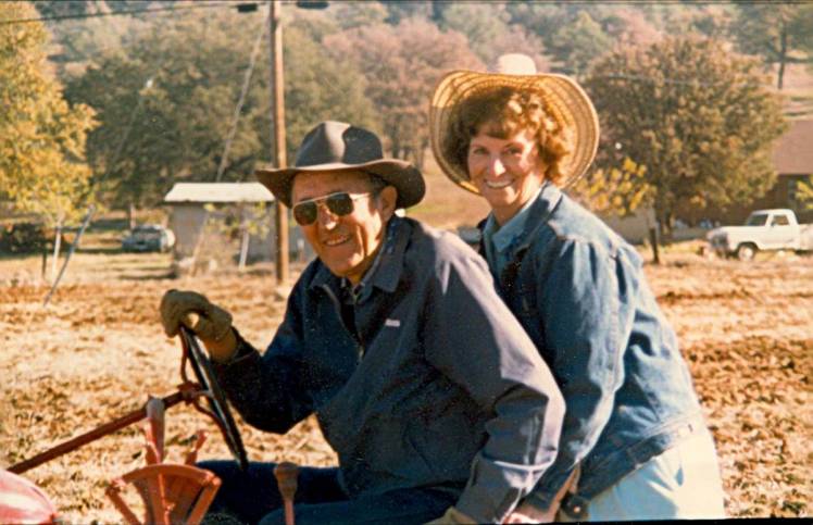 My father and mother sit astride his tractor on their land in Oroville, Calif. Circa early 90s.