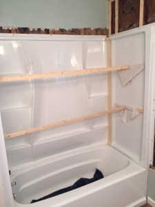 Shower enclosure going in (looks better now without the boards).